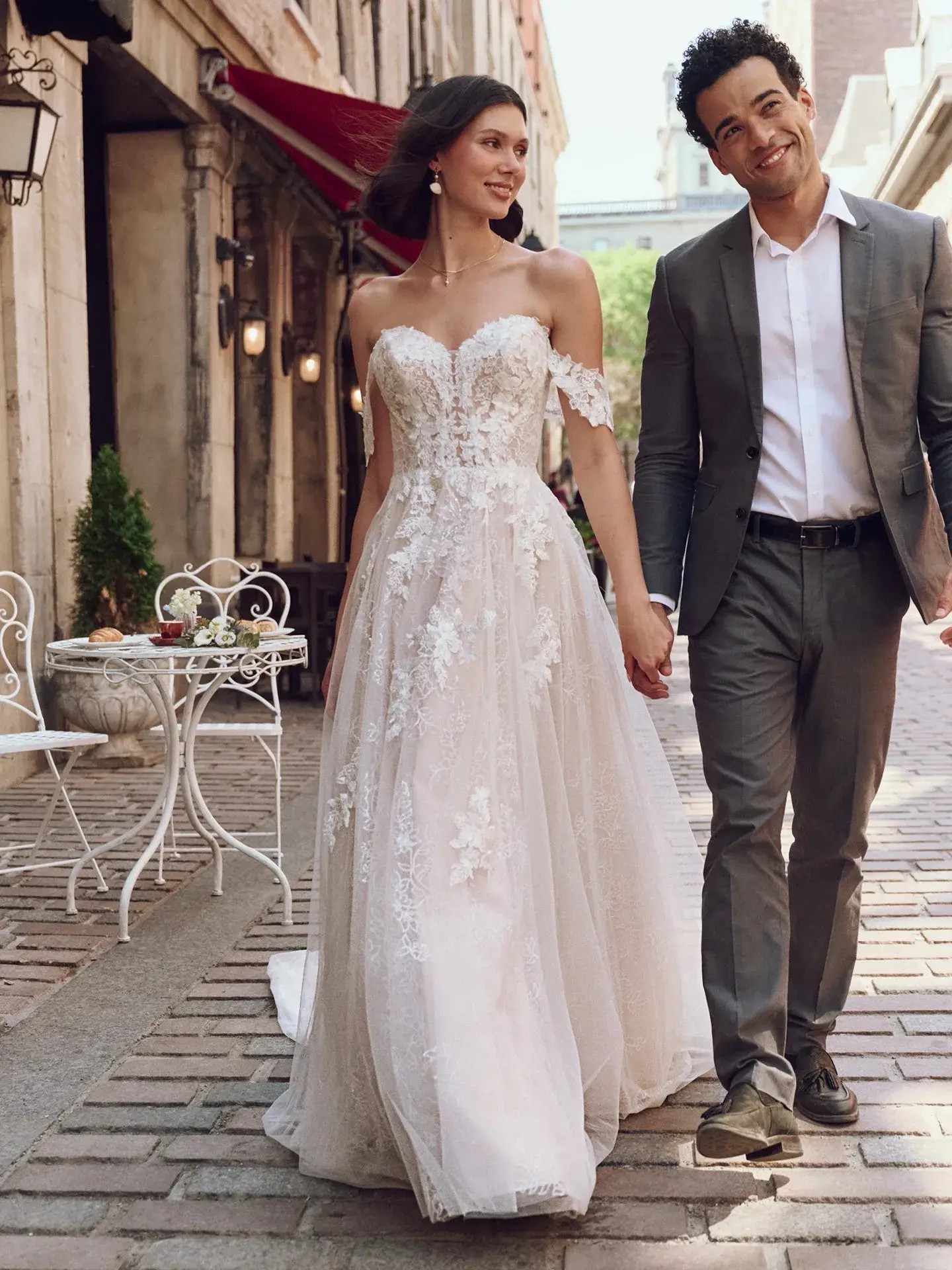 model is wearing an off the shoulder a-line wedding dress