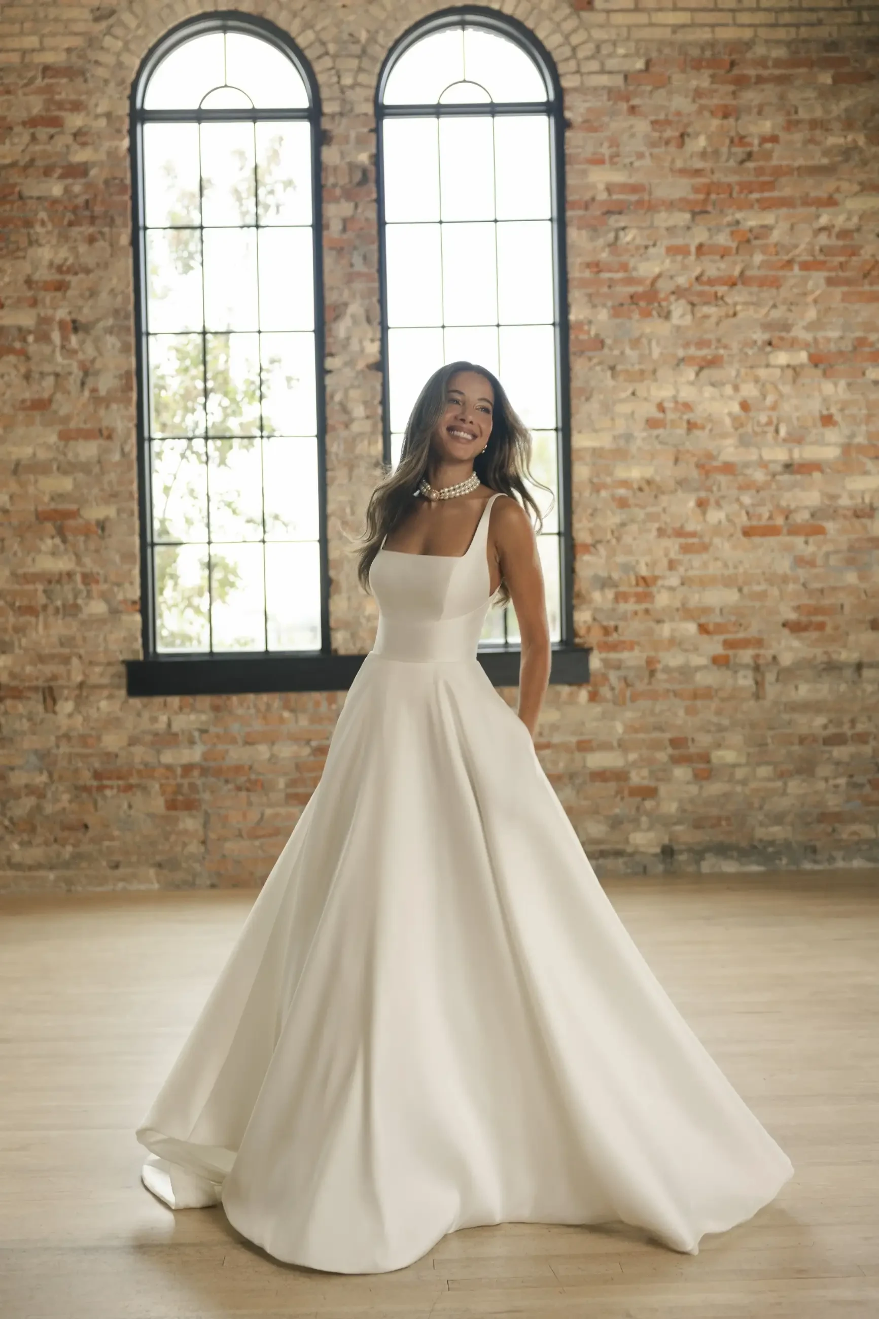 model is wearing a sleeveless a-line bridal gown