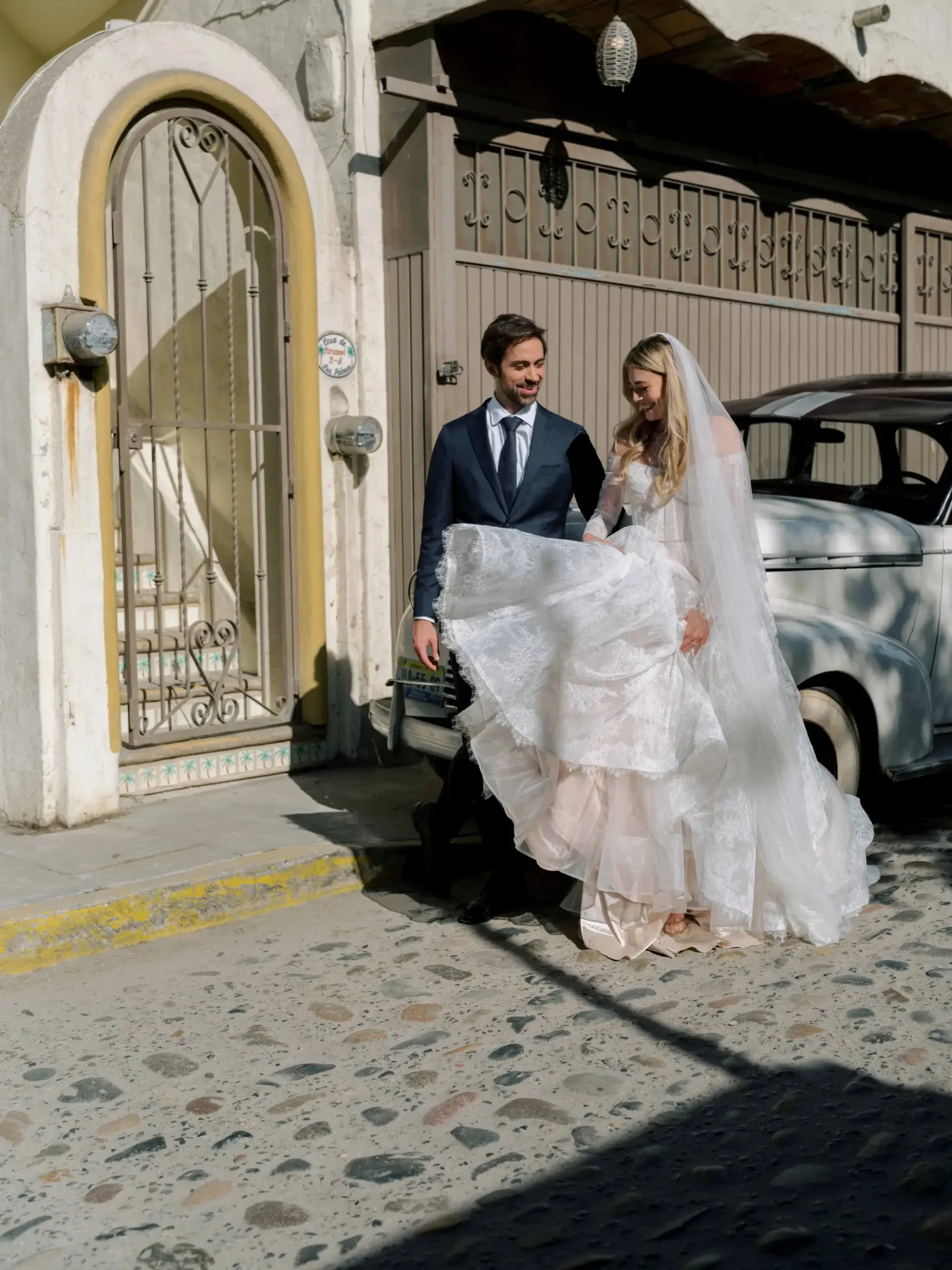 image shows a woman wearing a wedding gown and a man wearing a suit