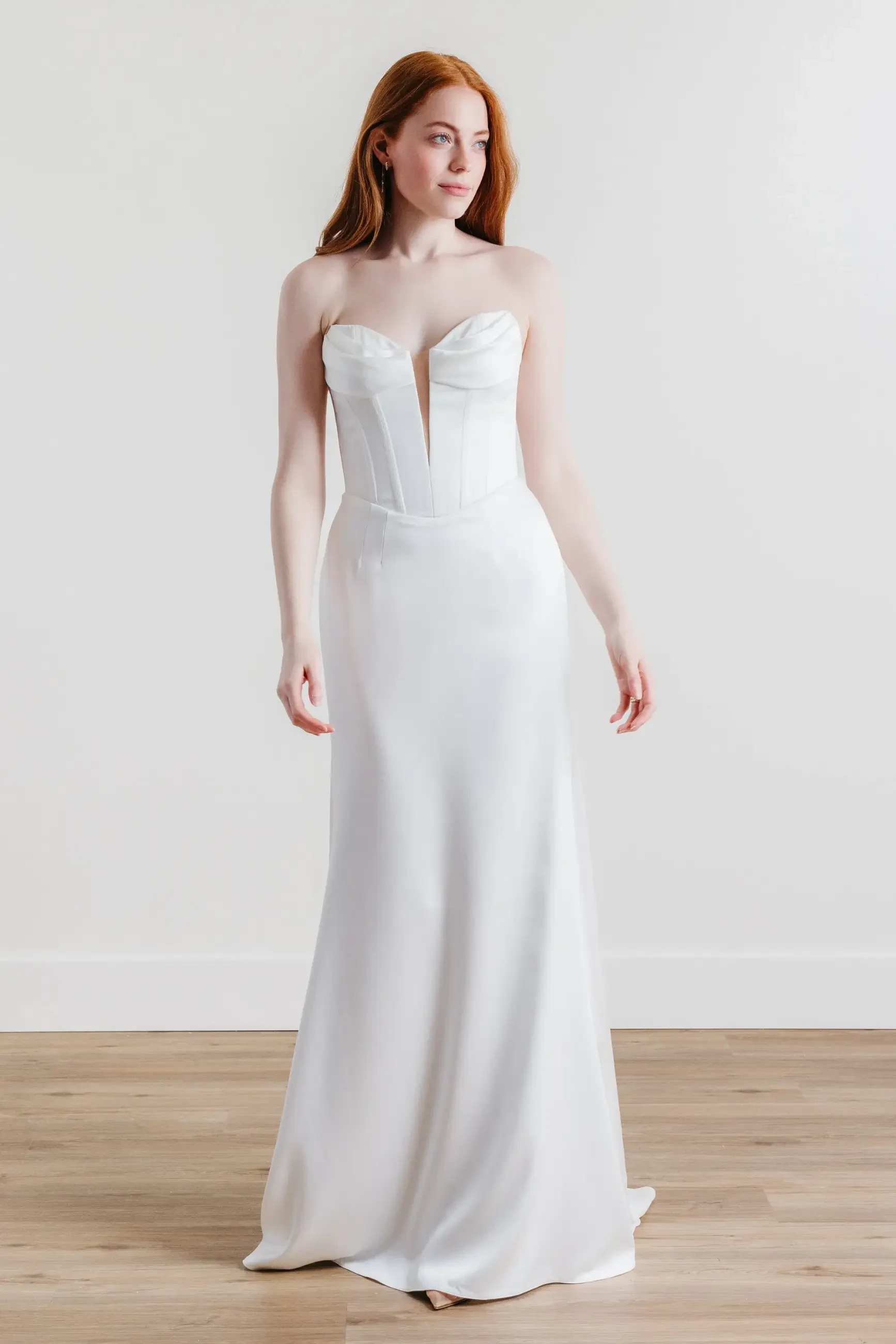 model is wearing a strapless fit and flare bridal gown