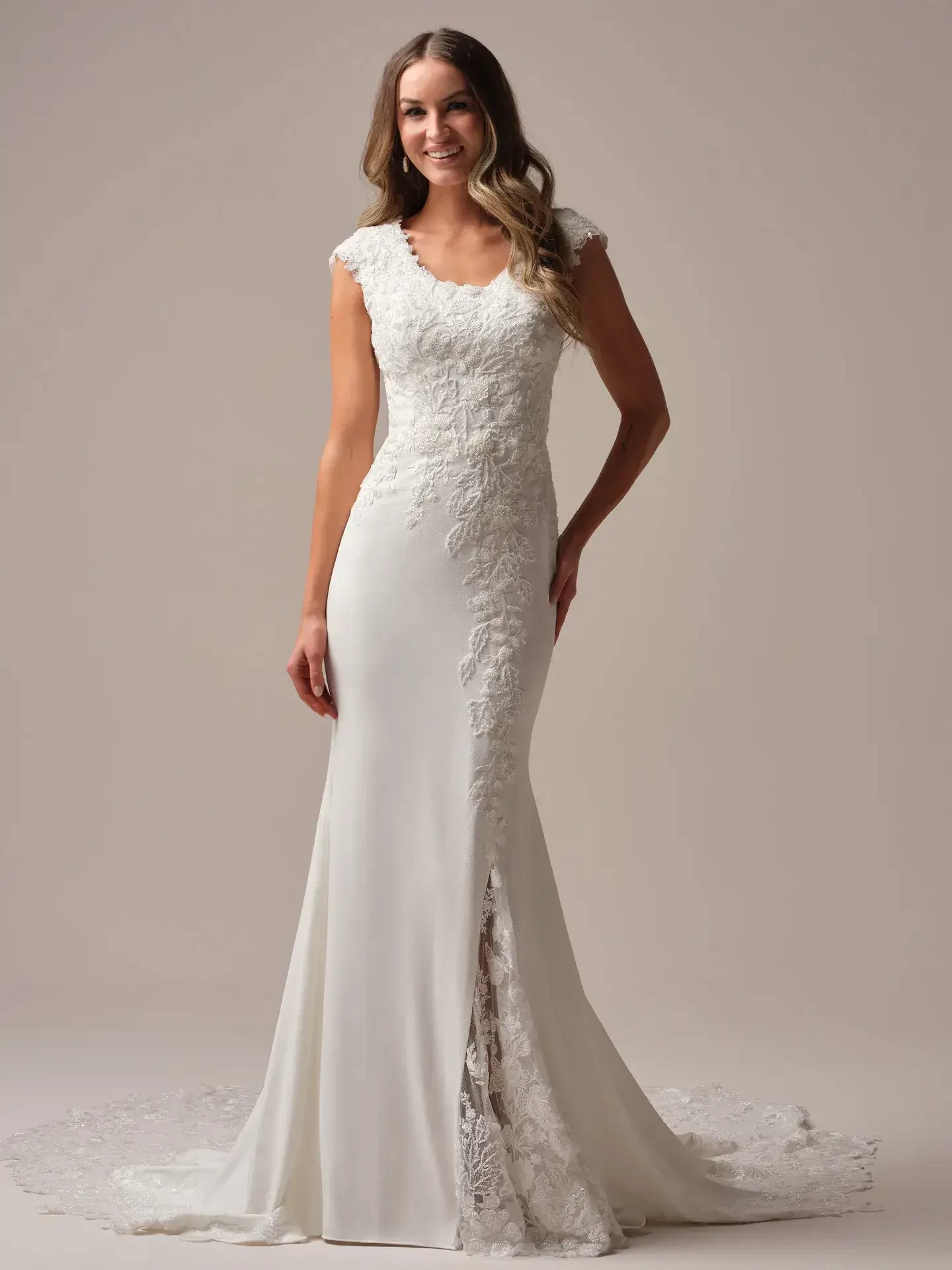 model is wearing a sheath bridal gown with nature inspired details