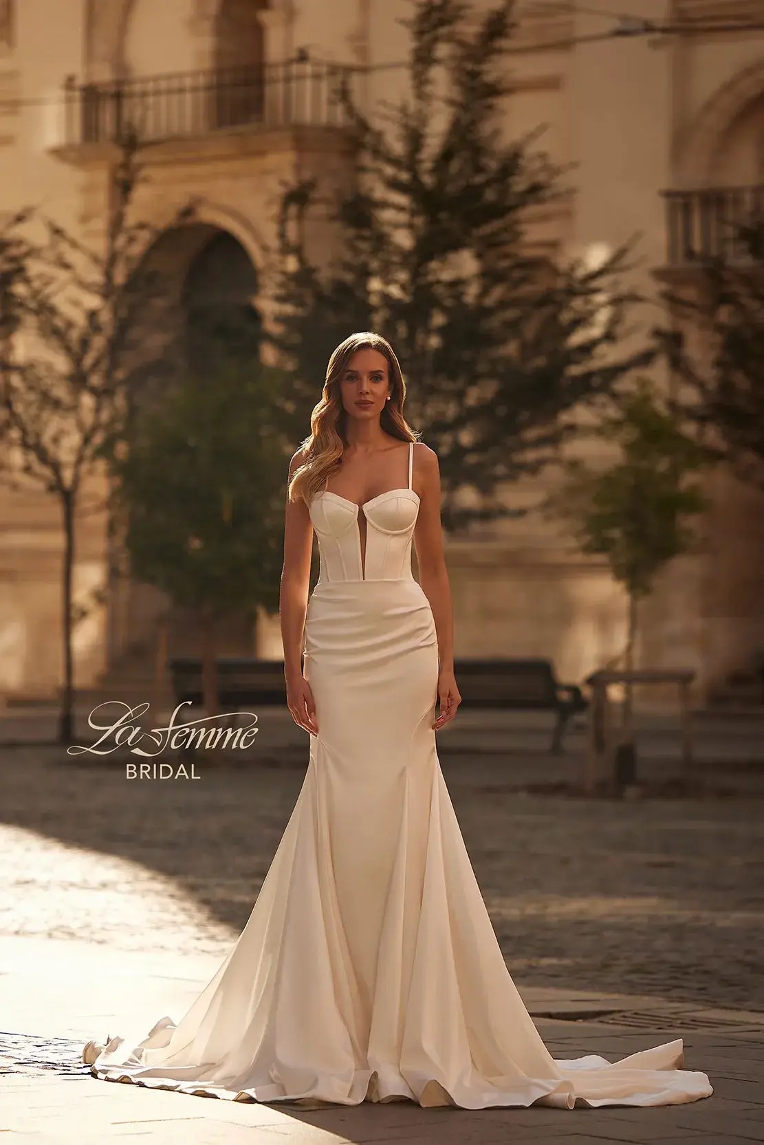 model is wearing a fitted sleeveless bridal gown 
