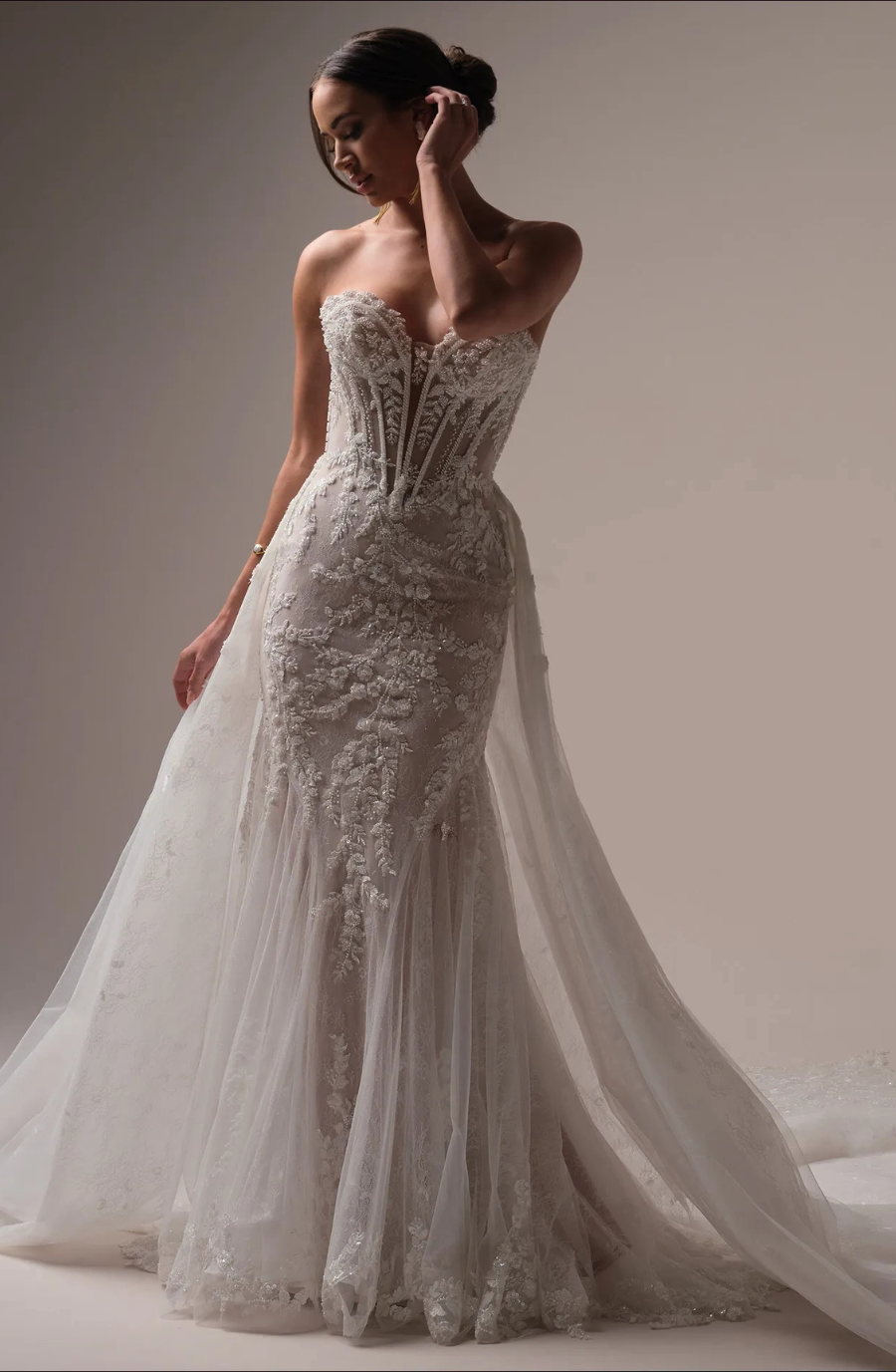 Model is wearing the Maggie Sottero Benjie Royale, a dazzling beaded mermaid gown with allover shimmer and a dramatic, fitted shape.