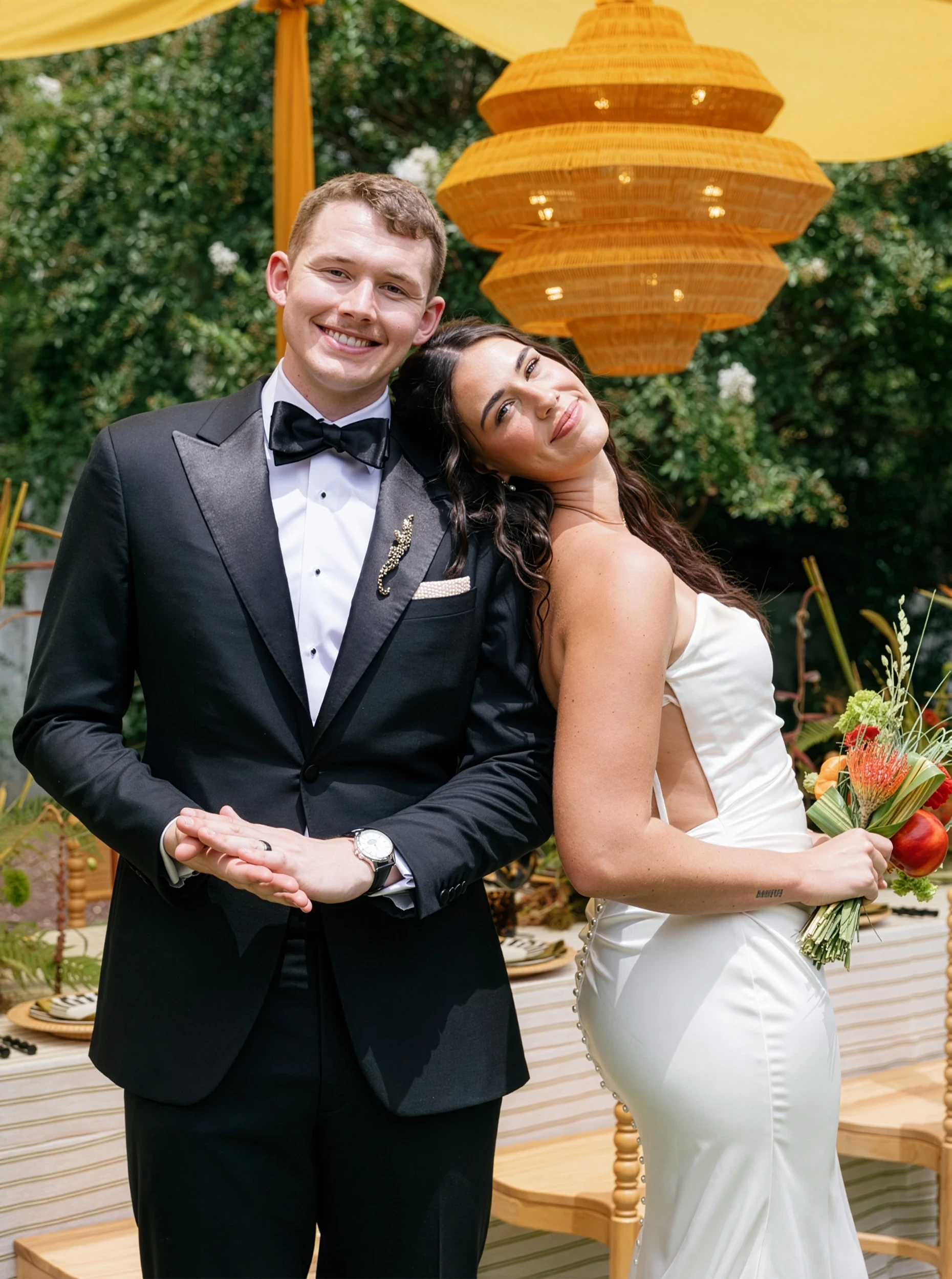 Сouple wearing a white gown and a black suit