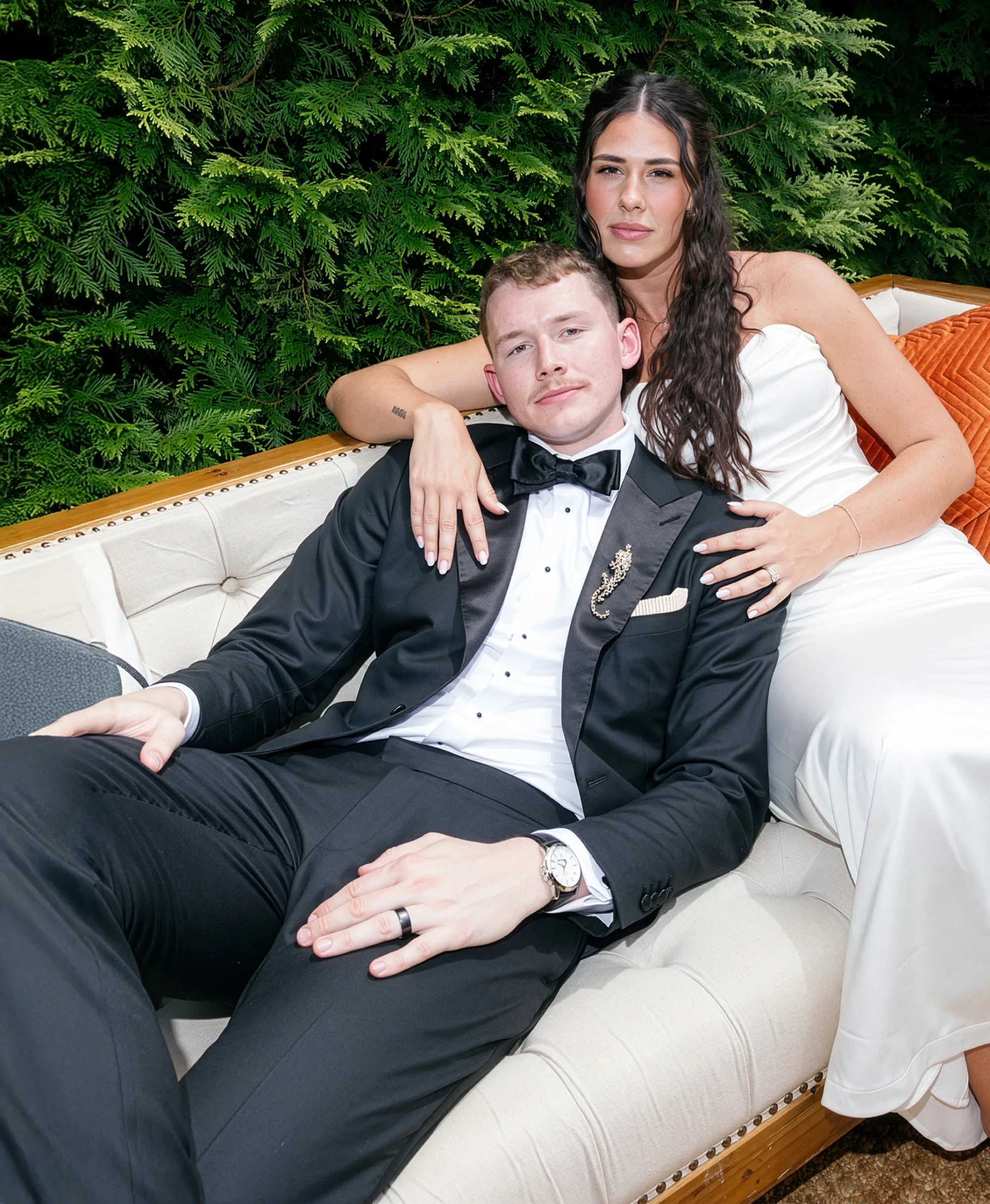 Сouple wearing a white gown and a black suit