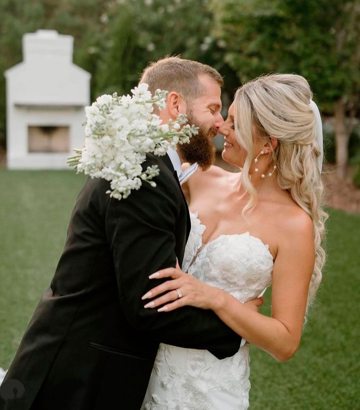 Сouple wearing a white gown and a black suit