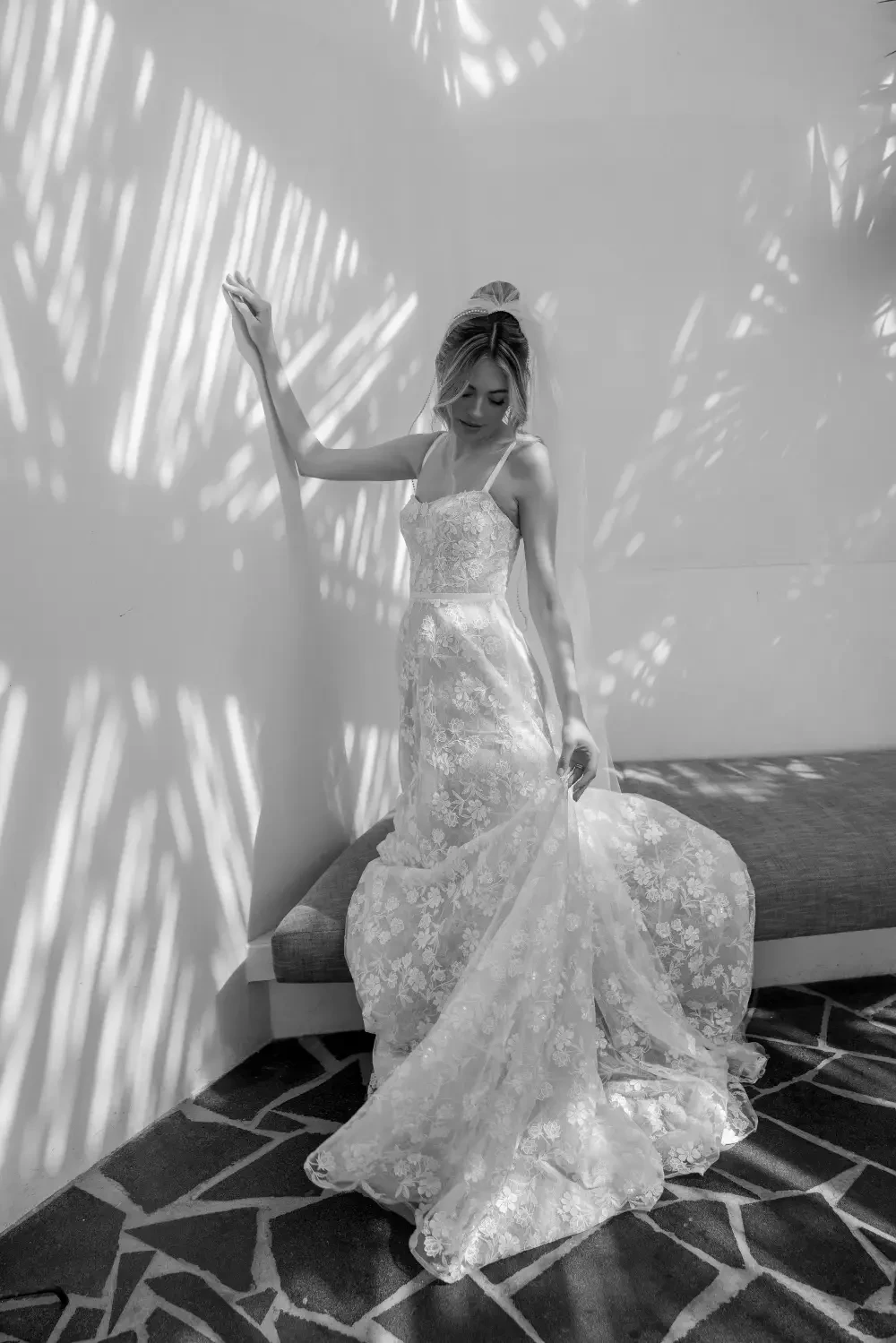 model is wearing a sleeveless a-line lace bridal gown