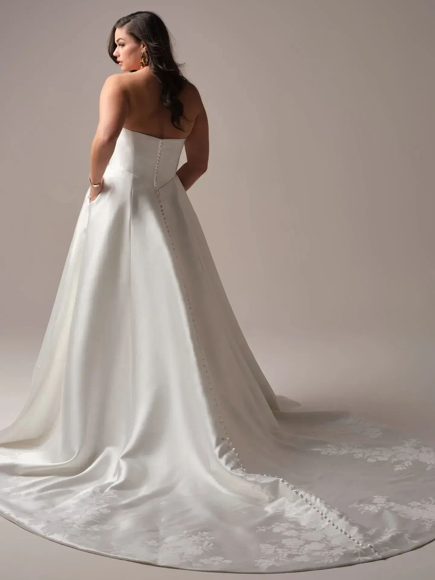 model is wearing a strapless ball gown wedding dress