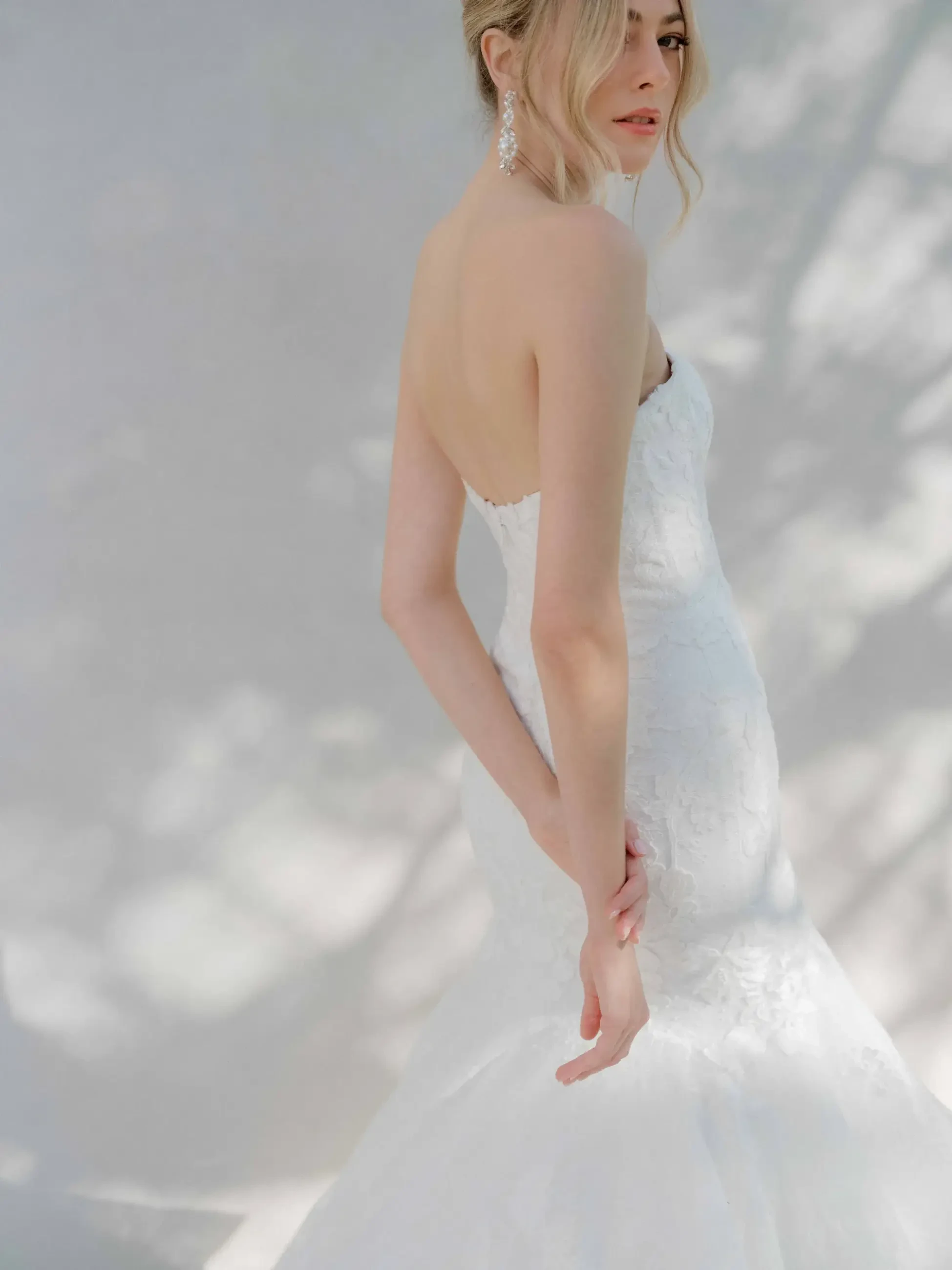 model is wearing a strapless fit and flare wedding gown