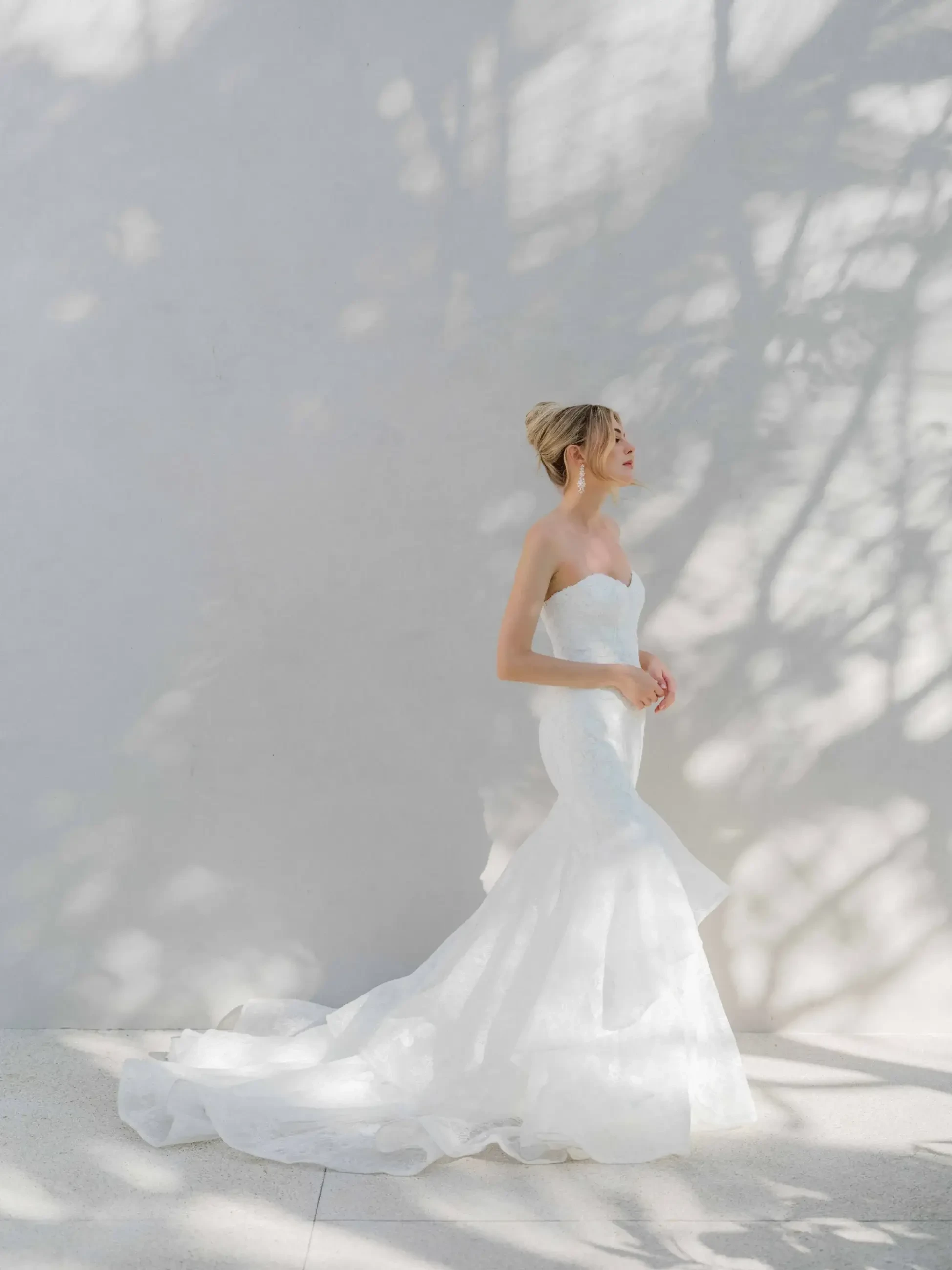 model is wearing a strapless fit and flare wedding gown